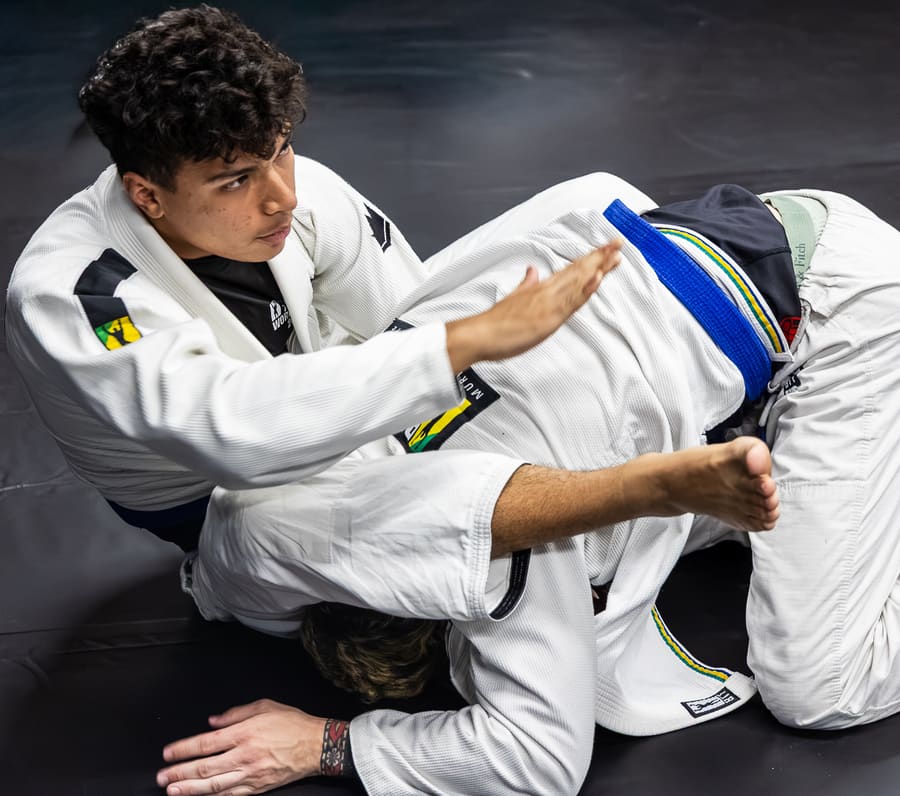 Two adults drilling a technique together on the mats at BTT Bridgewater